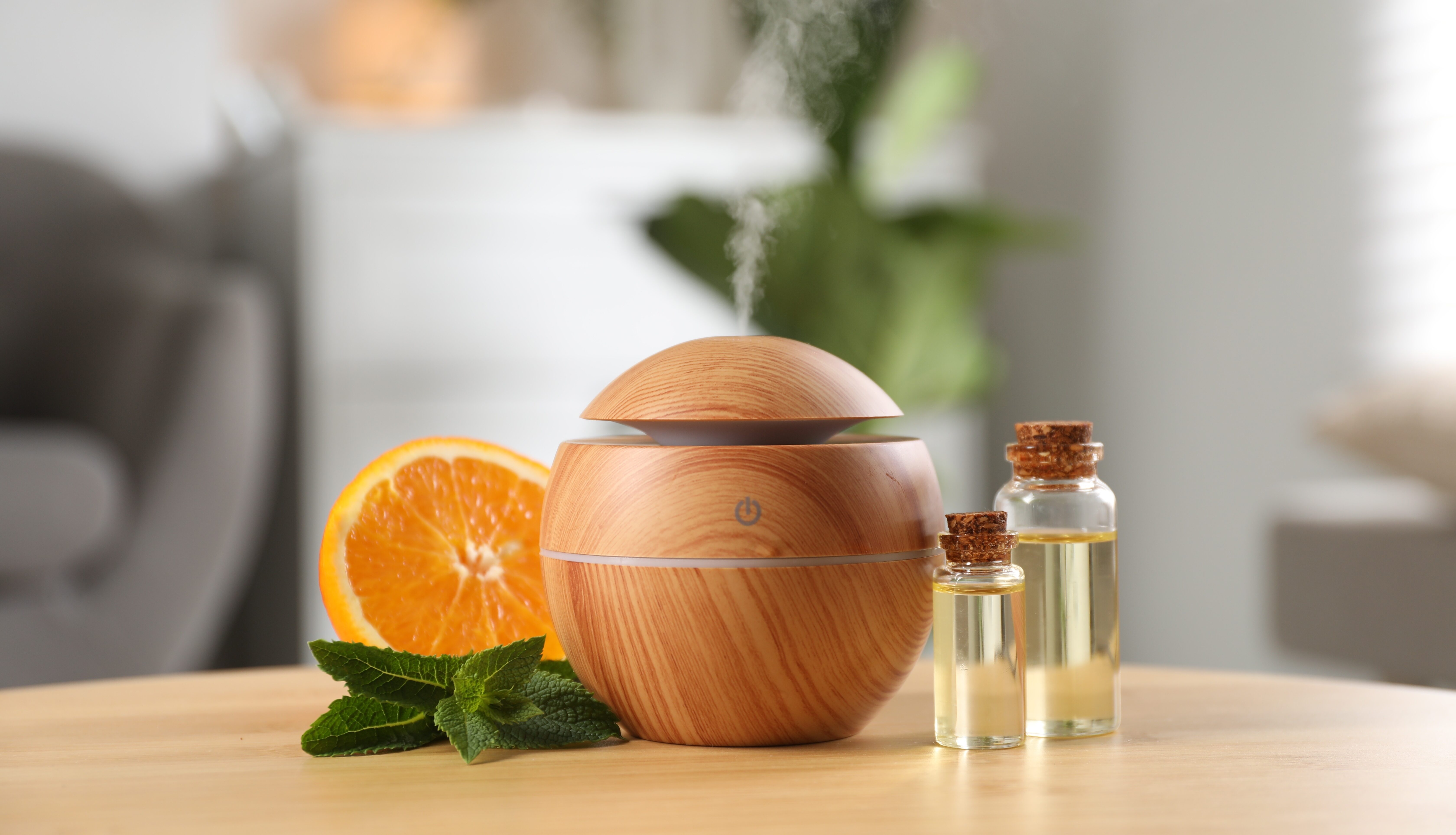 Essential,Oil,Diffuser,,Cosmetic,Products,,Mint,And,Orange,On,Wooden