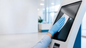 Disposable cleaning wipe being used to disinfect a high-touch surface